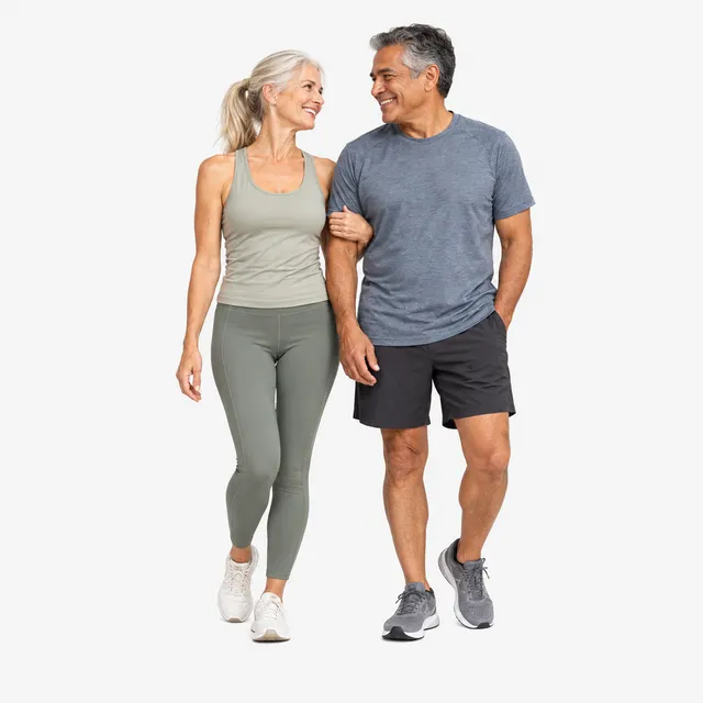 An older couple walking arm in arm
