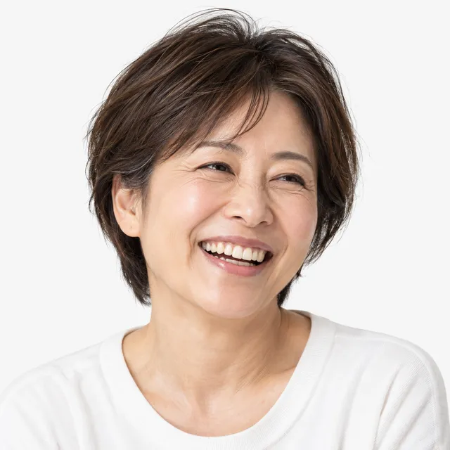A laughing woman with short brown hair in a white top