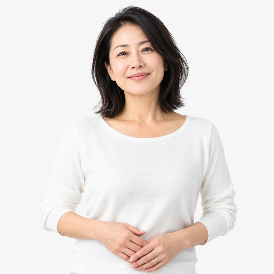 A smiling woman in a white sweater with her hands clasped