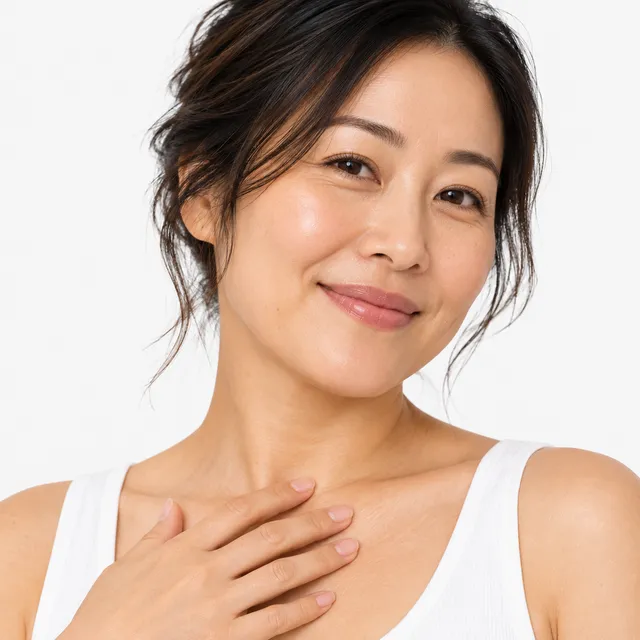 A smiling woman with her dark hair pinned up, one hand at her collarbone