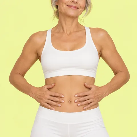 A woman in cream activewear with her hands on her waist