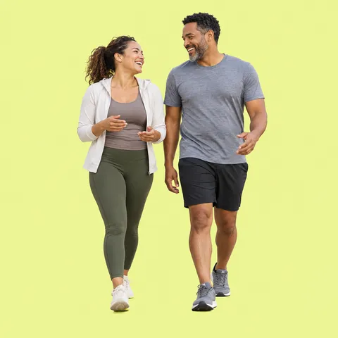 A laughing couple walking together in activewear