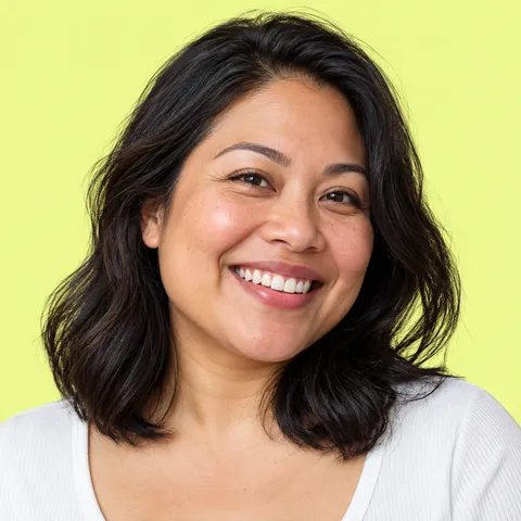 A smiling woman with shoulder-length dark hair